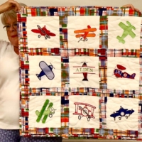 Sue D. with her airplane baby quilt.